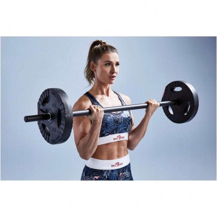 Donna che solleva bilanciere Gorilla Sports in palestra, abbigliamento fitness, bodybuilding