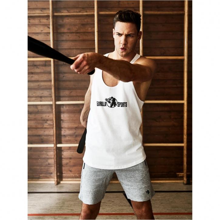 Uomo che si allena in palestra con tank top Gorilla Sports, bodybuilding fitness